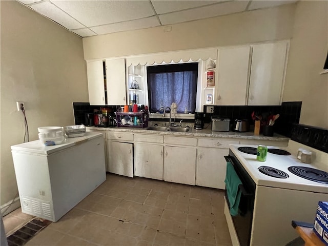 kitchen with sink, white cabinetry, a drop ceiling, fridge, and white electric range oven