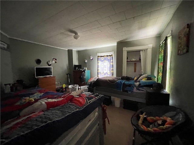 carpeted bedroom featuring crown molding