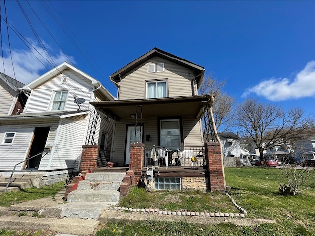 view of front of home with a front yard and a porch