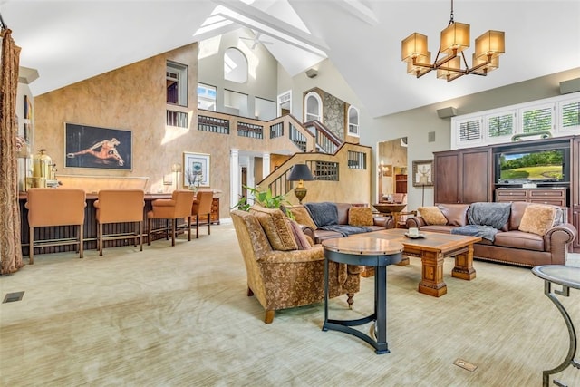 living room featuring light colored carpet, high vaulted ceiling, and ceiling fan with notable chandelier