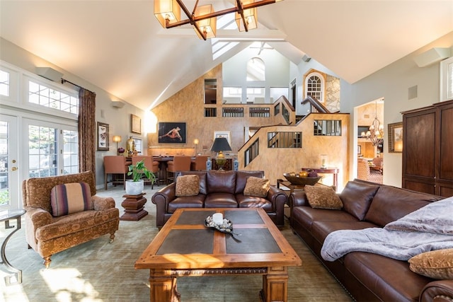 living room with a notable chandelier and high vaulted ceiling