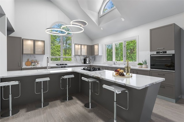 kitchen featuring hardwood / wood-style flooring, tasteful backsplash, a breakfast bar area, and stainless steel appliances