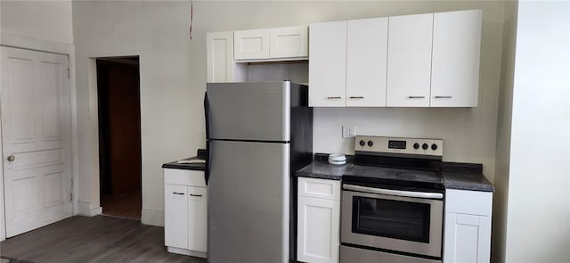 kitchen with white cabinets, appliances with stainless steel finishes, and dark hardwood / wood-style flooring