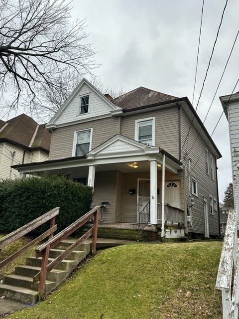 view of front of property with a front yard and covered porch