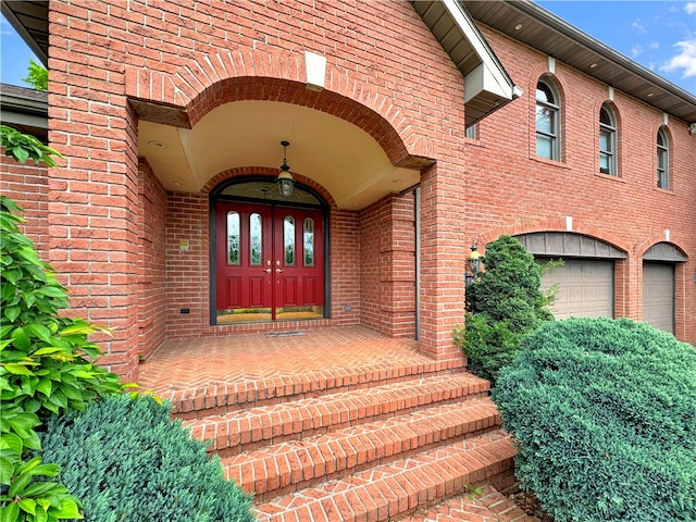 view of exterior entry with french doors and a garage