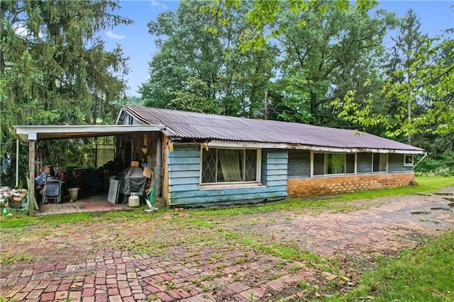 back of property featuring a carport