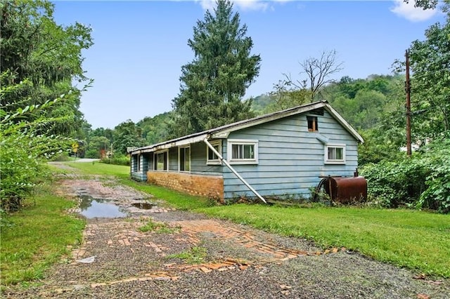 view of side of home with a yard