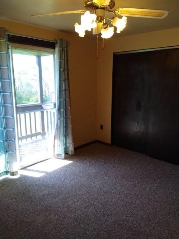 unfurnished bedroom featuring ceiling fan and carpet floors