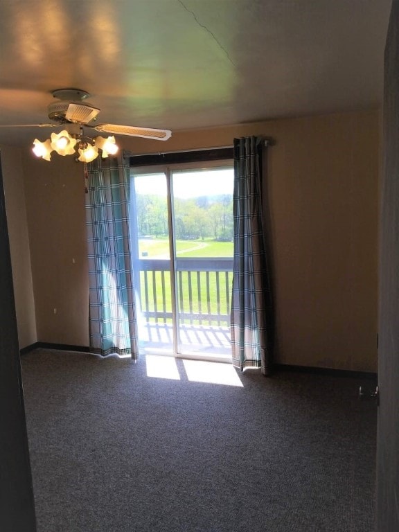 carpeted spare room featuring ceiling fan