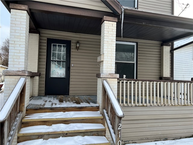 view of snow covered property entrance