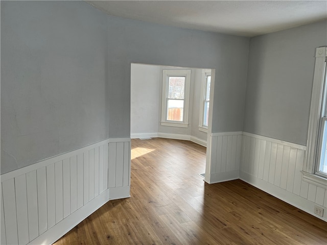 unfurnished room with hardwood / wood-style floors