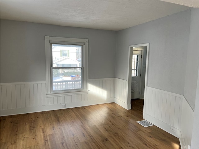 spare room with wood-type flooring