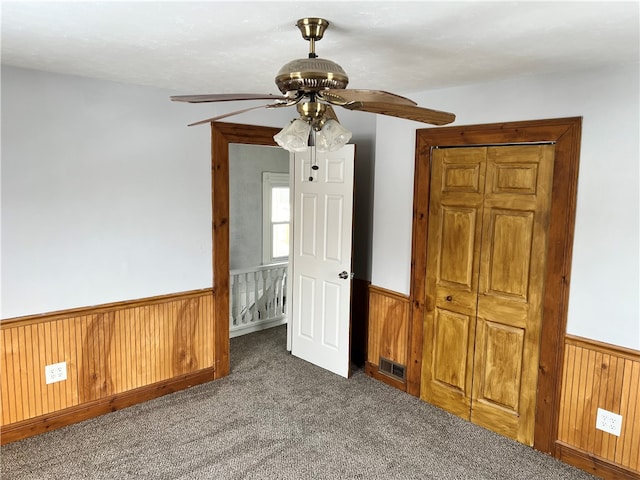 spare room with carpet floors and ceiling fan