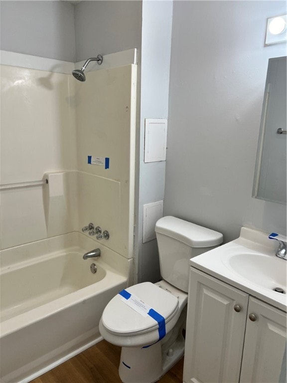 full bathroom featuring vanity, hardwood / wood-style flooring,  shower combination, and toilet