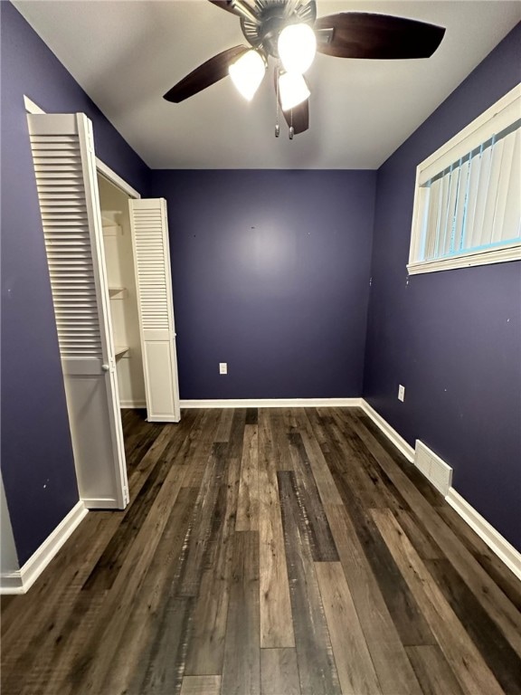 interior space featuring a closet, ceiling fan, and dark hardwood / wood-style flooring