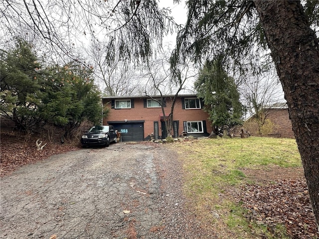 view of front of property with a front yard and a garage