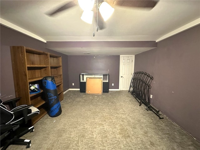 interior space featuring ceiling fan and dark carpet