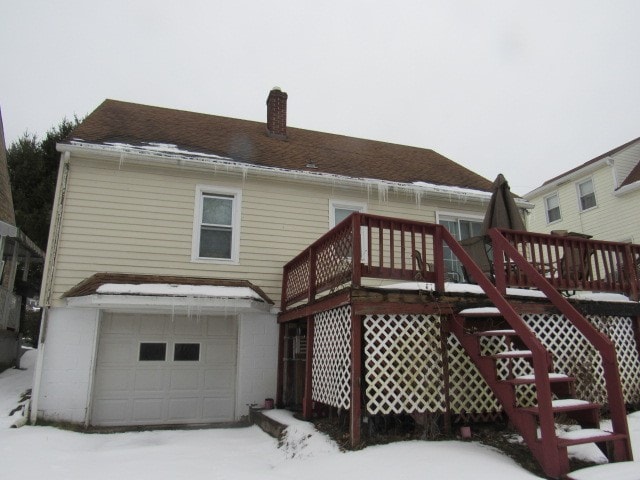 exterior space with a wooden deck and a garage