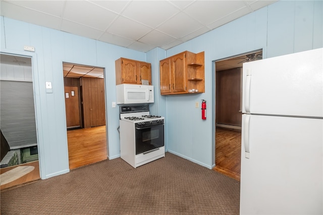 kitchen with white appliances, a paneled ceiling, baseboard heating, and carpet flooring