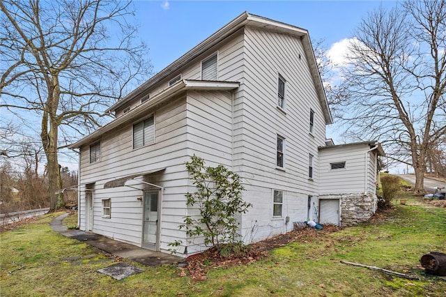 view of property exterior with a lawn