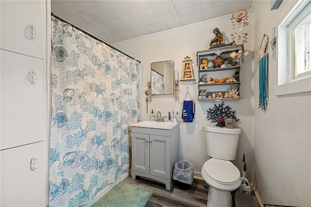 bathroom with vanity, hardwood / wood-style floors, toilet, and ornamental molding