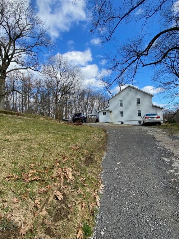 view of side of home featuring a yard