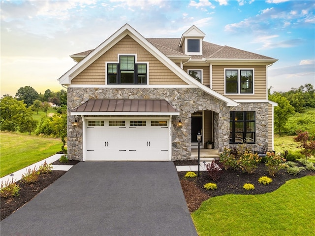 craftsman-style house with a yard and a garage