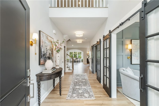 foyer entrance featuring light hardwood / wood-style floors and french doors