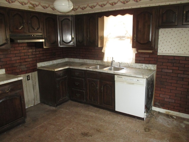 kitchen featuring white dishwasher, dark brown cabinetry, and sink