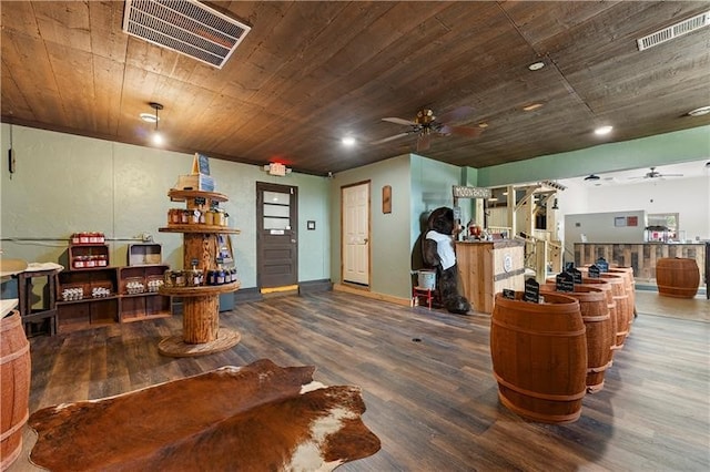 interior space featuring ceiling fan, dark hardwood / wood-style floors, and wooden ceiling