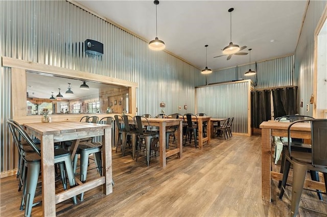 dining space with wood-type flooring