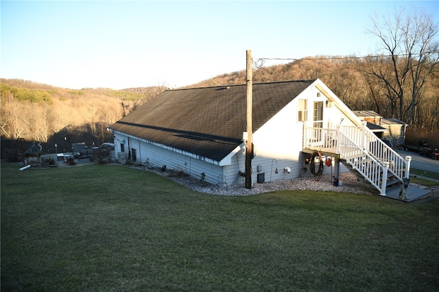 rear view of house featuring a lawn