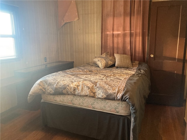 bedroom with dark hardwood / wood-style floors