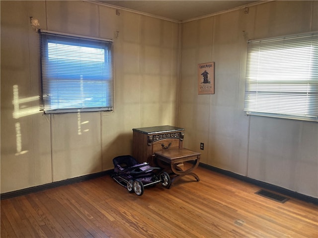 misc room with crown molding and light hardwood / wood-style flooring