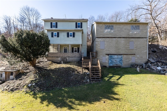 rear view of house featuring a yard