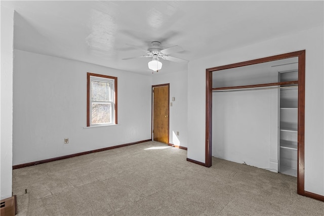 unfurnished bedroom featuring light carpet, a closet, and ceiling fan