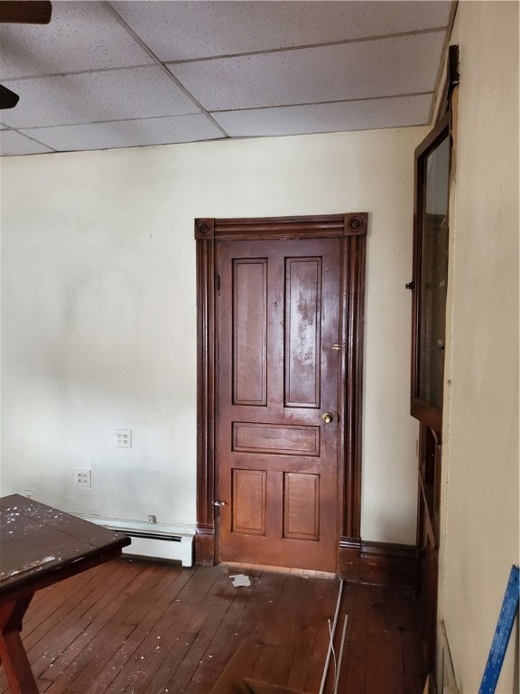 doorway to outside with a paneled ceiling and wood-type flooring