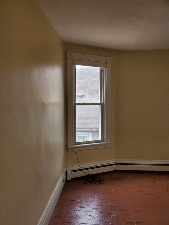 empty room with hardwood / wood-style floors and a wealth of natural light