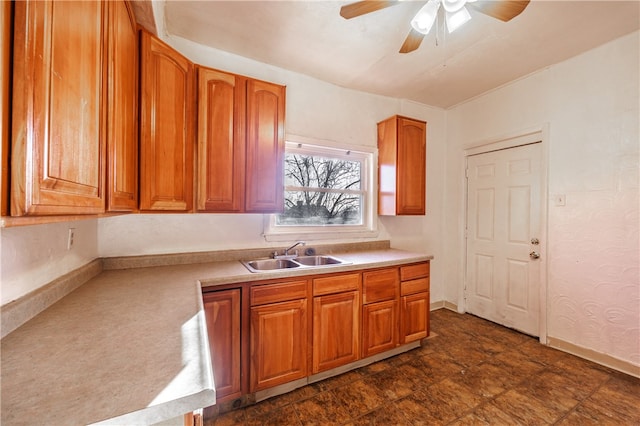 kitchen with ceiling fan, sink, and dark tile floors