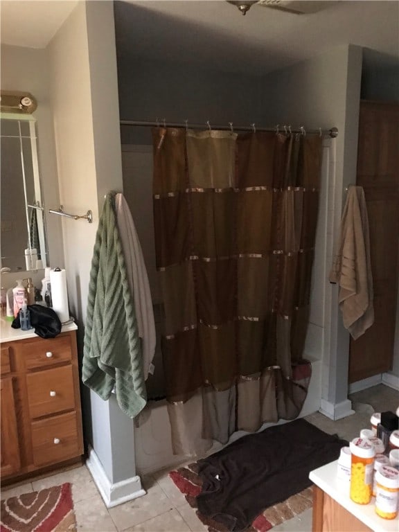 bathroom with tile floors and vanity