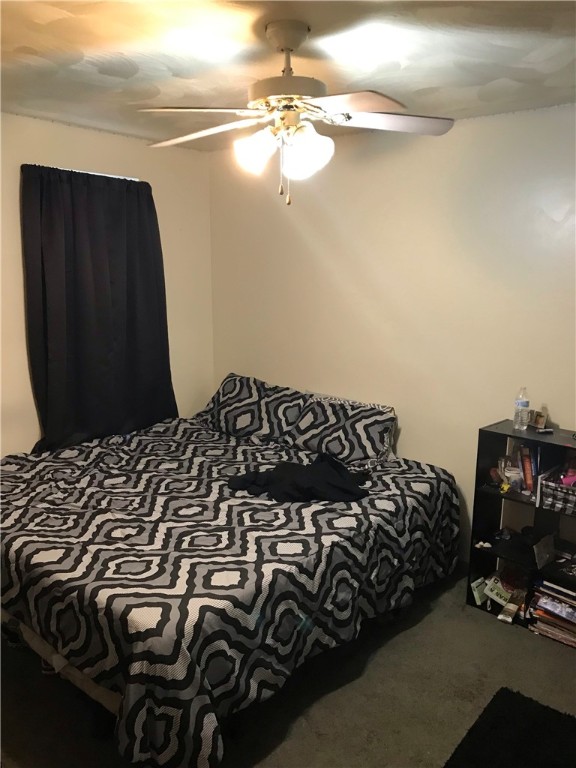 carpeted bedroom featuring ceiling fan