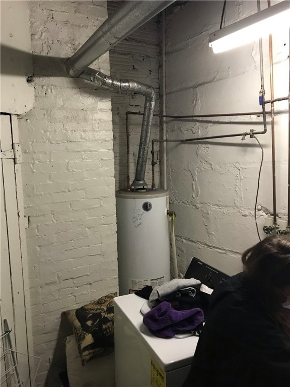 utility room with gas water heater