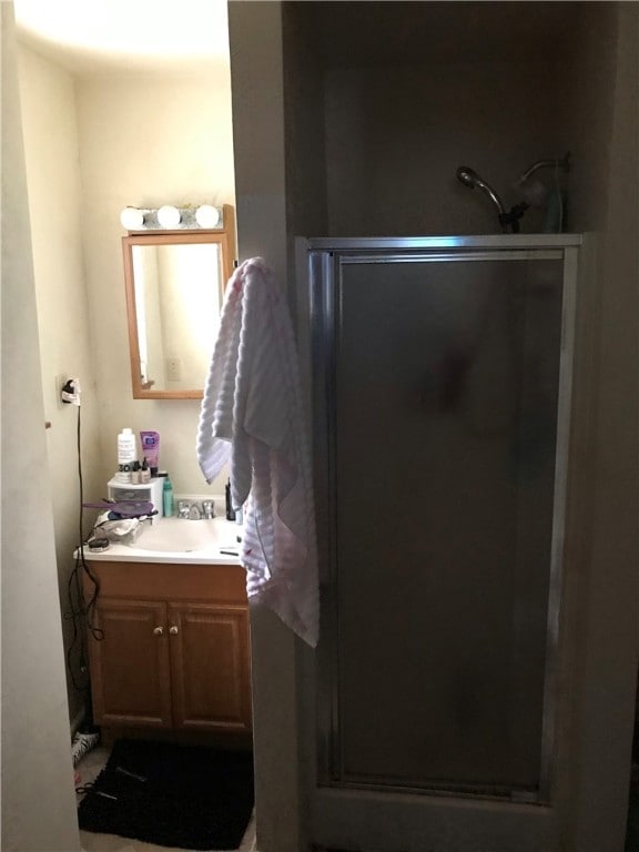 bathroom featuring an enclosed shower and vanity