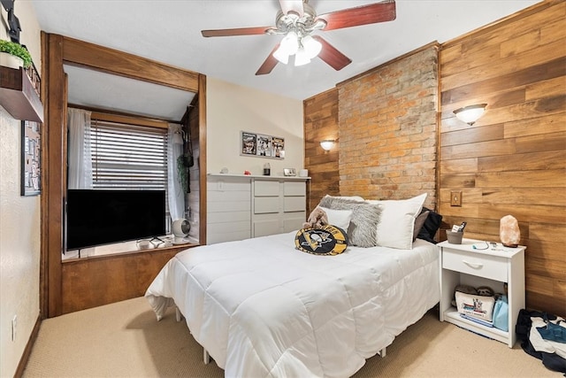 bedroom with brick wall, light colored carpet, and ceiling fan