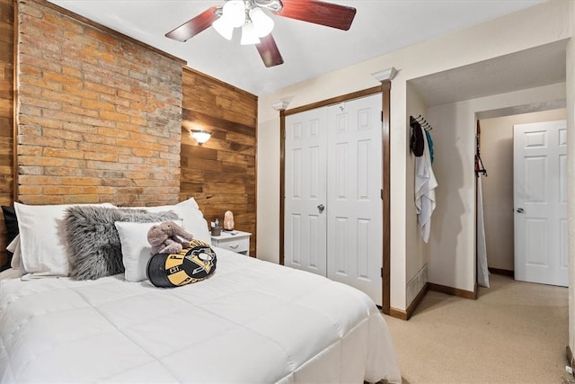 bedroom featuring light carpet, a closet, and ceiling fan