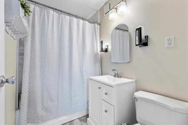 bathroom featuring tile floors, toilet, and vanity