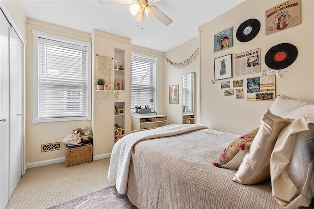 bedroom featuring light carpet and ceiling fan