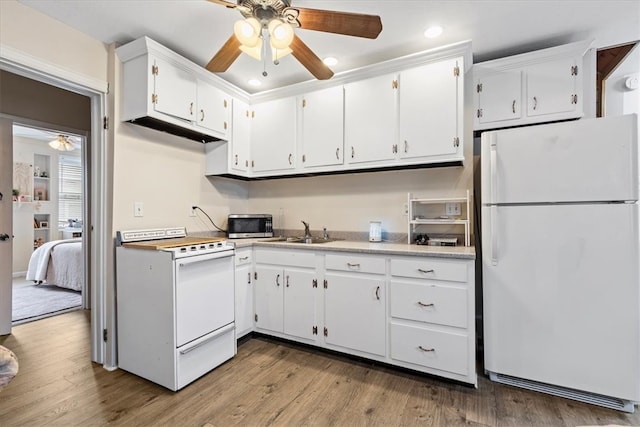 kitchen with ceiling fan, white appliances, light wood-type flooring, and white cabinetry