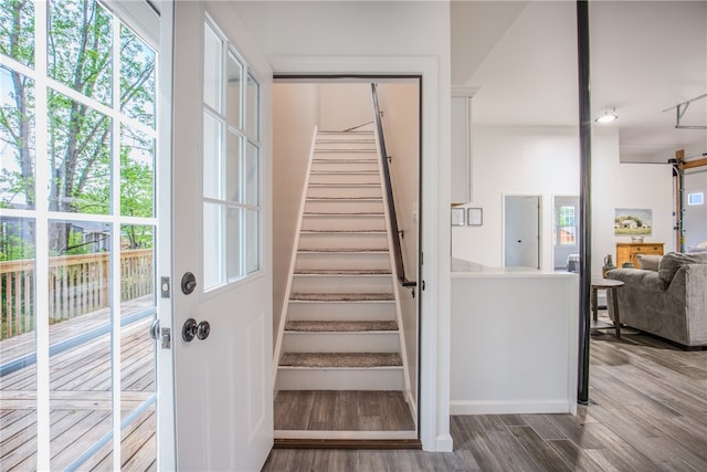 stairs featuring hardwood / wood-style flooring