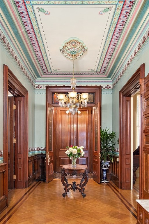 interior space with light parquet flooring and a notable chandelier